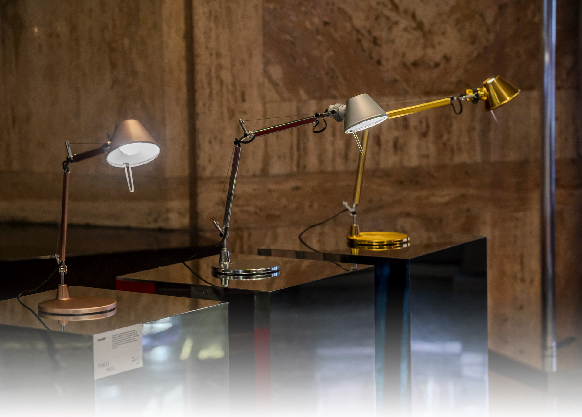 Image of three Tolomeo Micro Table displayed at the exhibition.