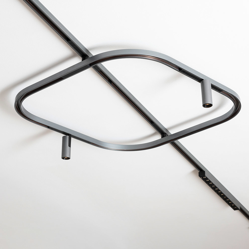 Ceiling-mounted Turn Around lighting system with two adjustable LED spotlights installed on a track.