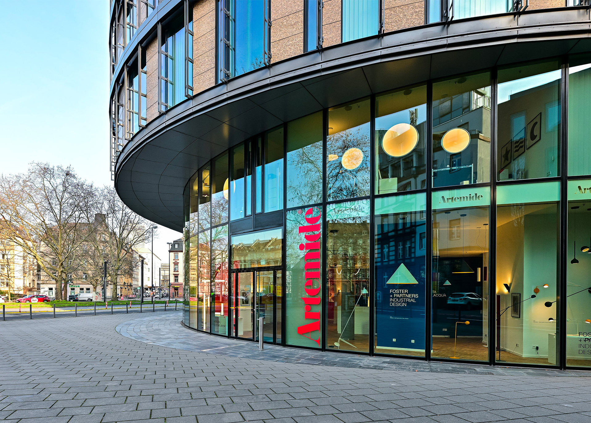 Artemide showroom entrance with glass facade and lighting visible inside.
