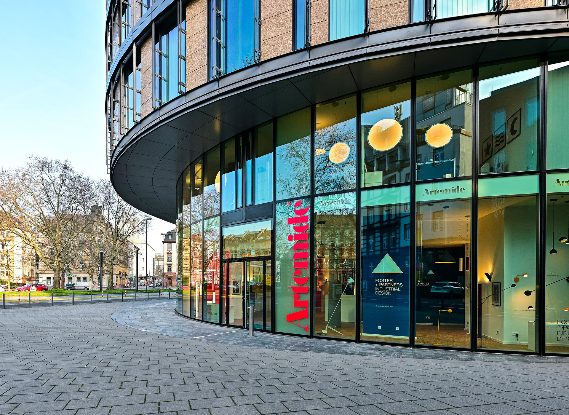 Artemide showroom entrance with glass facade and lighting visible inside.