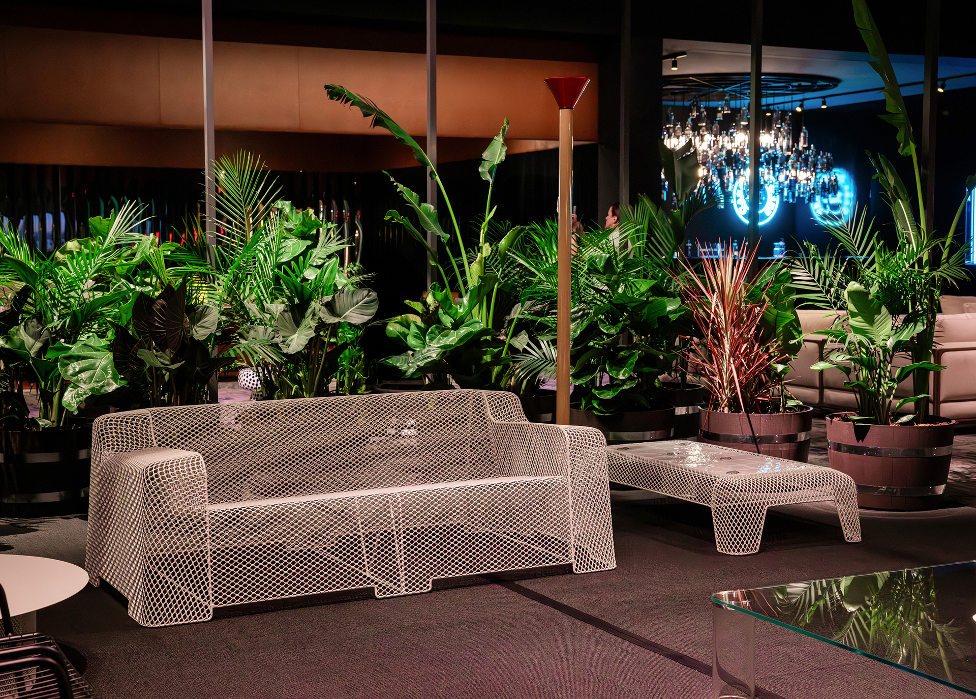 Photo of the installation for Salone del Mobile.Milano in Riyadh: a red cell-like structure displaying the products, accompanied by a red staircase that follows its profile.
