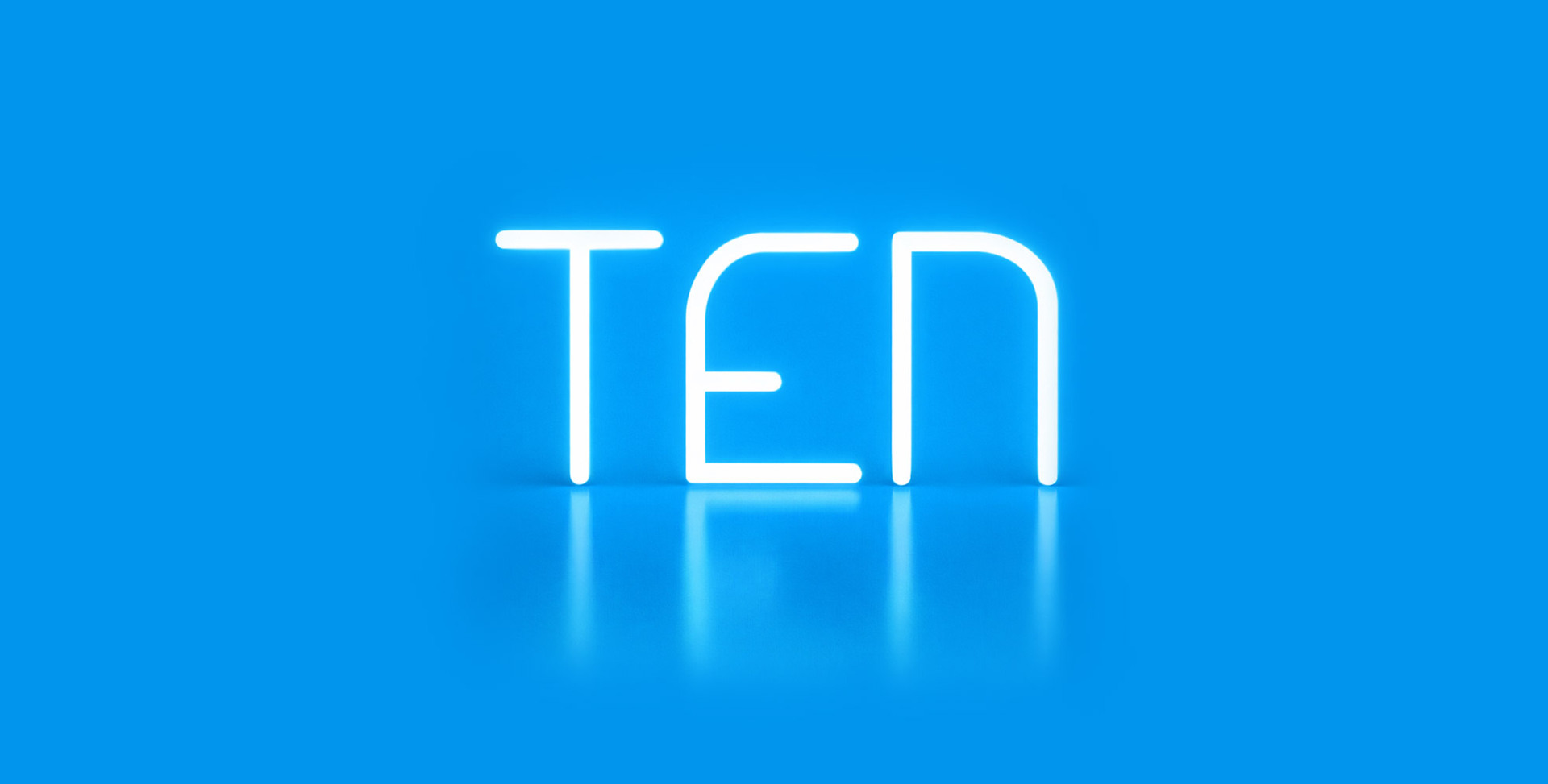 Illuminated “TEN” lettering created with Alphabet of Light, set against a blue background with reflection on the glossy surface.