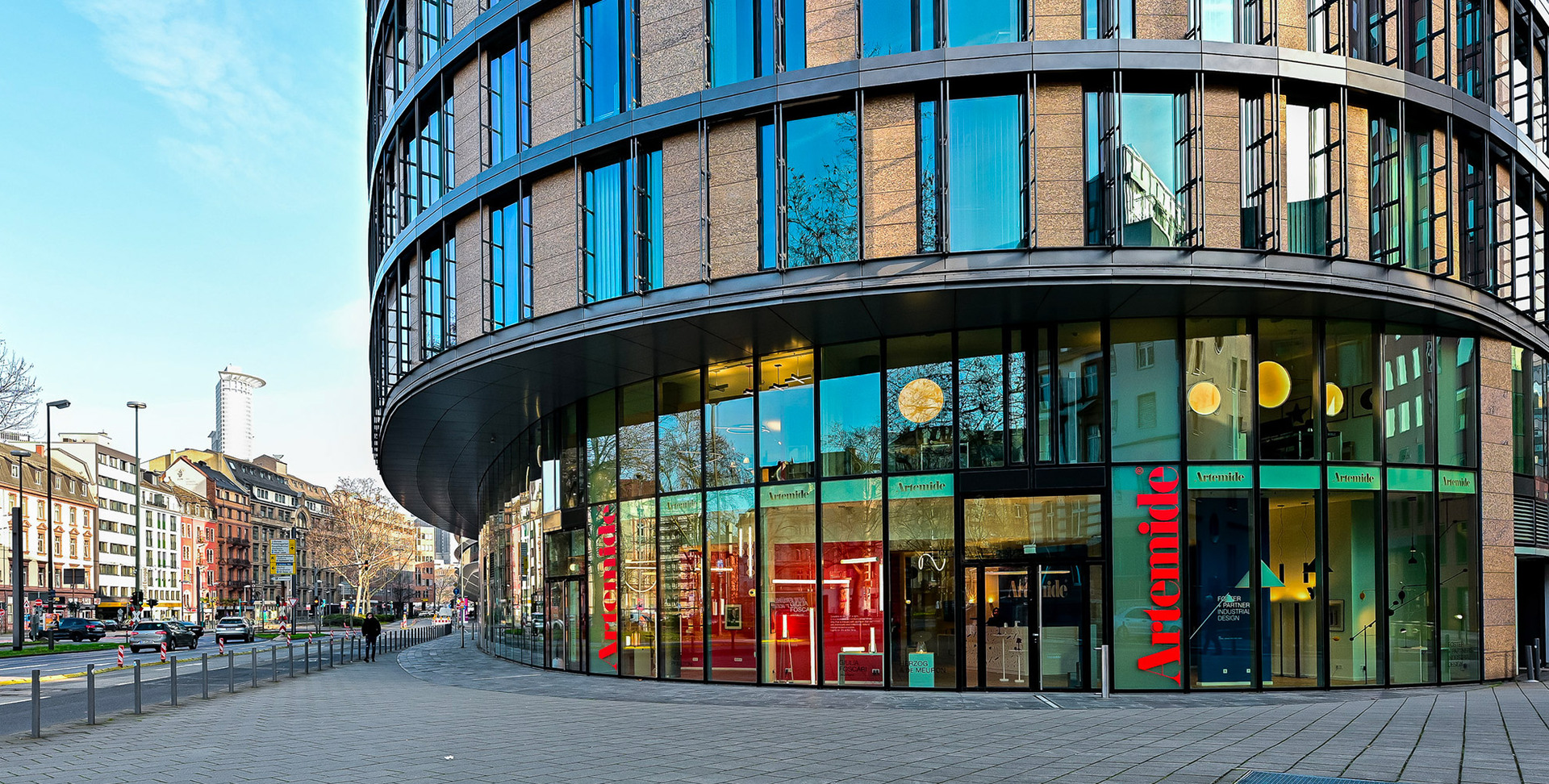 Artemide showroom entrance with glass facade and lighting visible inside.