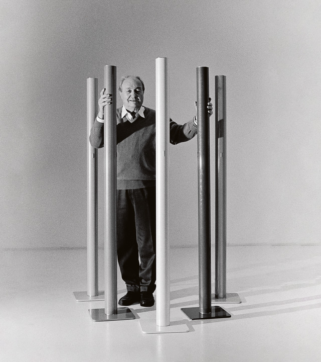 Picture of Ernesto Gismondi photographed full-length with the Ilio lamps around him.