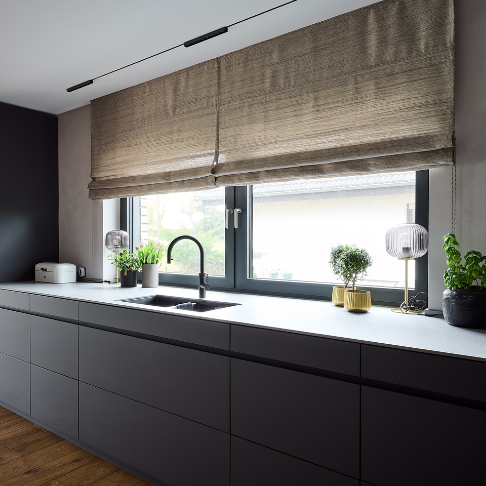 Linear kitchen with dark gray cabinetry, a large window above the worktop, and Turn Around lighting.