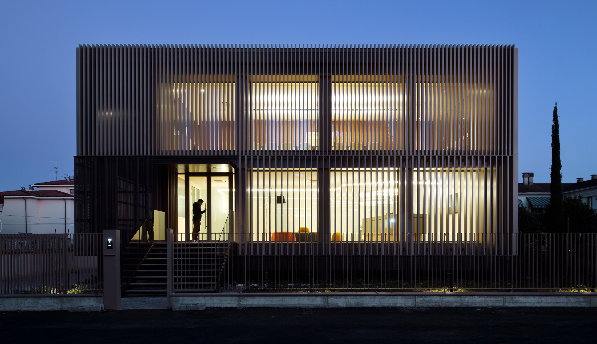 Front view of the external façade of the new Fornaroli Polymers headquarters in the evening.