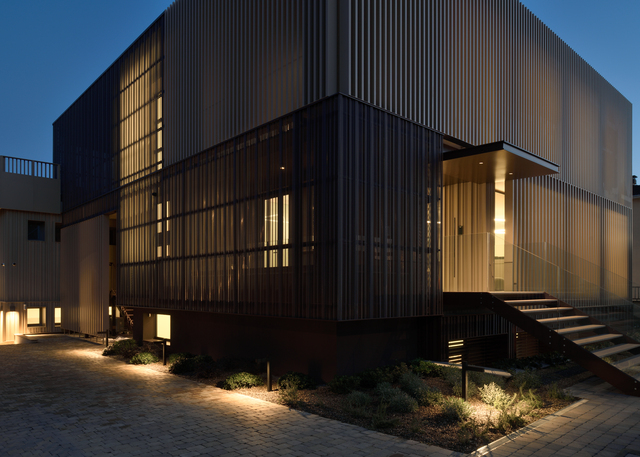 Angled external view of the new Fornaroli Polymers headquarters with a pathway illuminated by Walking Pole bollards.