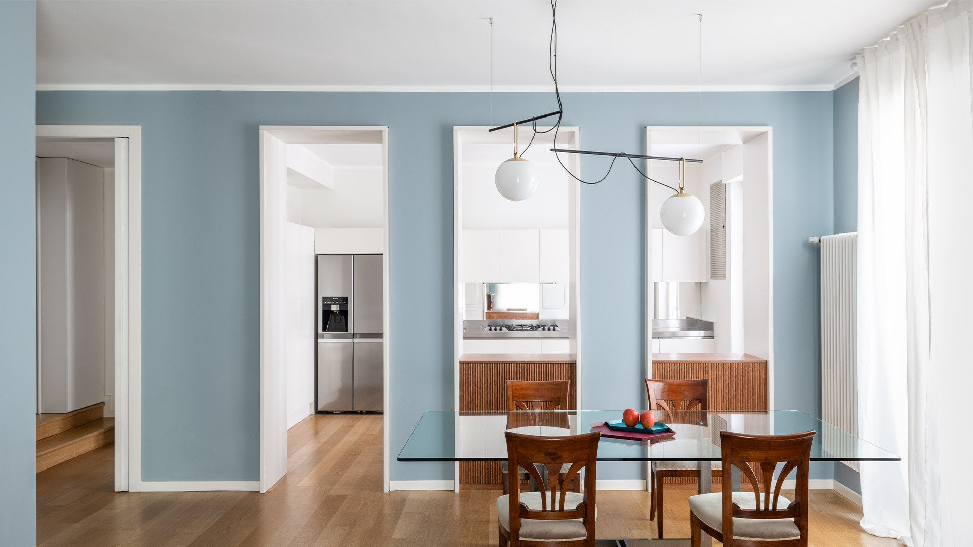 Tre lampade a sospensione Artemide NH con sfere in vetro bianco opalino di diverse dimensioni, raccordi in ottone, sospese su cavi neri